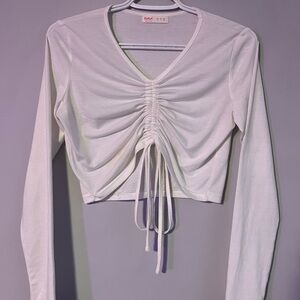 White long sleeve top. Adjustable strings